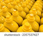 Group of yellow mustard squeeze bottles. Mustard retail display.