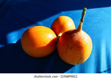 Group Of Yellow Passionfruit On A Blue Background