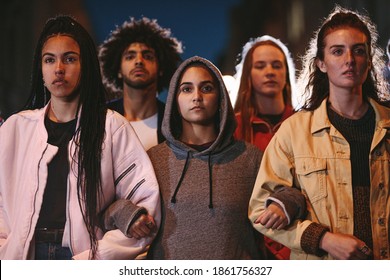 Group of young activists marching together holding hands. Male and female protestors demonstrating a change in society. - Shutterstock ID 1861756327