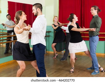 Group Of Young Adults Having Tango Class At Dance Studio. Selective Focus
