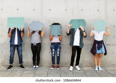 Group of young adults outdoors holding empty placard copyspace thought bubbles - Powered by Shutterstock