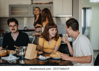 A group of young adults share a hearty meal and laughter in a contemporary kitchen setting, showcasing friendship and happiness during a casual gathering. - Powered by Shutterstock