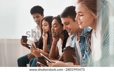 Group Of Young Adults Using Mobile Phones In Office, Happy And Engaged, Business Concept