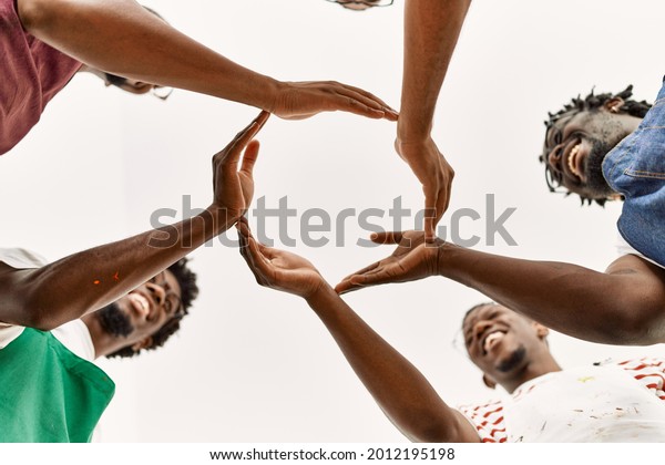 Group of young african\
american artist man smiling happy doing circle with hands together\
at art studio.