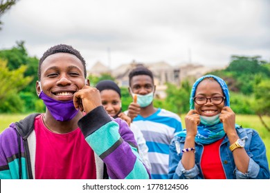 Group Of Young African People Wearing Face Masks, With Physical Distancing, Smiling