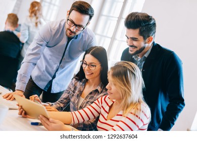 Group of young architects using digital tablet
