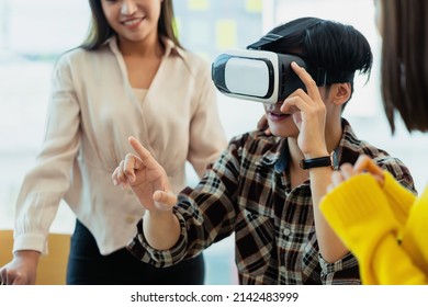 Group Of Young Asian Business People Using Virtual Reality Glasses During Meeting Testing Virtual Reality Headset And Exchange Project Ideas Shared To Improve The Visual Experience.