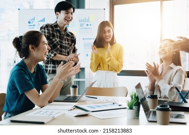 Group of young asian business people in smart casual wear working together in creative office using laptop. - Shutterstock ID 2158213883