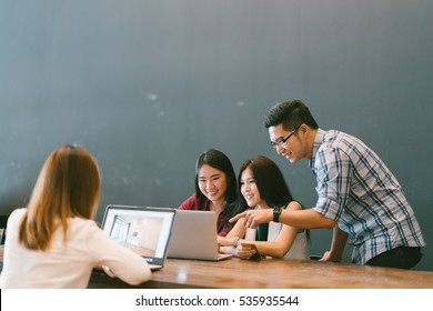 Group Of Young Asian Business People In Team Casual Discussion, Startup Project Business Meeting Or Happy Teamwork Brainstorm Concept, With Copy Space, Depth Of Field Effect