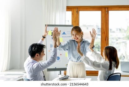 Group of Young Asian business team creative businesspeople coworker in office Happy to be successful partnership teamwork celebrating achievement and success concept. - Shutterstock ID 2136544643