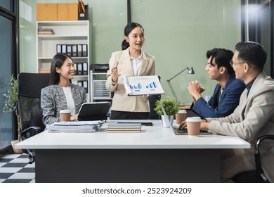 Group of Young Asian business team creative businesspeople coworker in office. Meeting Presentation for analysis graph company financial. People Work in Business Office.