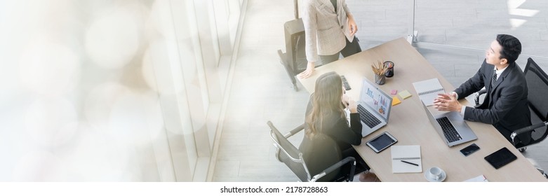 A Group Of Young Asian Businessmen Talking And Planning Work Happily And Have Fun. At The Company's Office Web Banner With Copy Space On Left