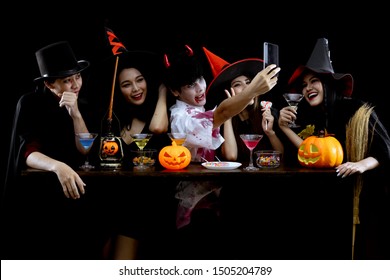 Group Young Asian In Costume Celebrate Halloween Party And Selfie On Black Background. Gang Of Teen Asian In Cosplay Halloween. Costume Ghost, Evil Of Group Teen Thai With Fun.