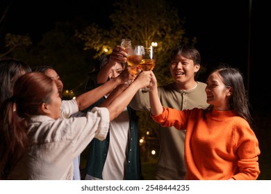 Group of young Asian friends enjoying dinner party together Barbecue grilling, drinking beer, people, food, healthy fruits and vegetables, celebrating, lifestyle drinks. New Year celebration concept. - Powered by Shutterstock