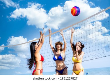 Group of young asian girl in bikini playing volleyball on the beach, Group of woman friends playing beach volley, Group of happy friends plays with ball at sunset beach.