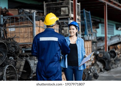 Group Of Young Asian Male And Female Employee Worker Using Clipboard Checking Old Automotive Spare Parts, Engine, Motor, Machine At The Garage Industry Factory Or Automotive Spare Parts Warehouse