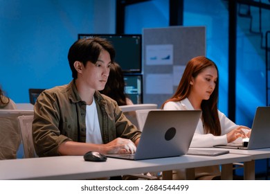 Group of young Asian Software Developers Talk,Discuss a Technological Project prompt app program nomad AI.Ux and Ui Developer Designer brainstorming algorithms on computer screen in office.