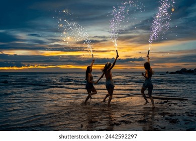 Group of Young Asian woman dancing and playing sparklers firework together at tropical island beach in summer night. Attractive girl enjoy and fun outdoor lifestyle travel ocean on holiday vacation. - Powered by Shutterstock