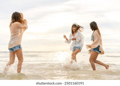 Group of Young Asian woman enjoy and fun outdoor lifestyle travel nature ocean on summer beach holiday vacation. Attractive girl friends walking and playing together at the sea on tropical island. - Powered by Shutterstock