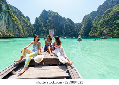 Group of Young Asian woman friends sitting on the boat passing island beach lagoon in summer sunny day. Attractive girl enjoy and fun outdoor lifestyle travel on summer holiday vacation in Thailand - Shutterstock ID 2253884321