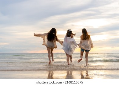  Group of Young Asian woman in walking and playing together on tropical beach at summer sunset. Happy female friends enjoy and fun outdoor activity lifestyle on holiday travel vacation at the sea - Shutterstock ID 2168115375