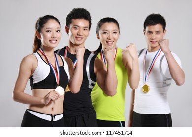 Group Of Young Athletes Wearing Medals