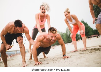 Group Young Attractive People Having Fun On Beach And Doing Some Fitness Workout.