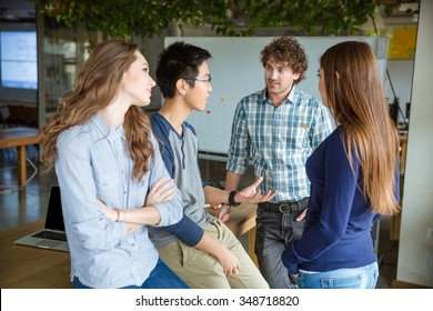 Group Of Young Attractive People Talking And Discussing New Project In Meeting Room