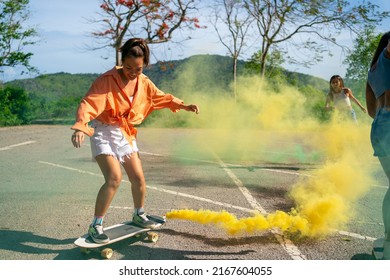 Group Of Young Beautiful Asian Woman Skateboarding Together At Skate Park On Summer Vacation. Happy Active Female Friends Enjoy Outdoor Activity Lifestyle And Extreme Sport Surf Skate At Public Park.