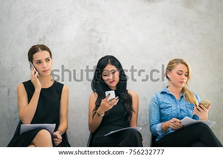 A group of young beautiful woman are typing text message or surfing internet on their smartphone in retro tone