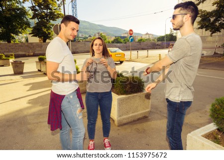 Group of young best friends having fun together walking on town street. Young and carefree concept.