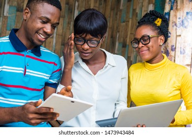 Group Of Young Black Colleagues In An Office Working Together With Laptop And Tablet