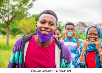 Group Of Young Black People Wearing Face Masks, With Physical Distancing, Smiling