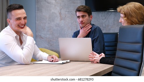 Group of a young business people discussing business plan at modern startup office building - Shutterstock ID 681278293