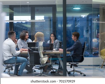 Group of a young business people discussing business plan at modern startup late night office building - Shutterstock ID 701570929