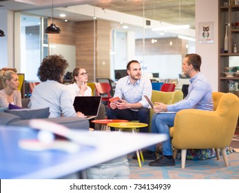 Group of a young business people discussing business plan at modern startup office building - Shutterstock ID 734134939