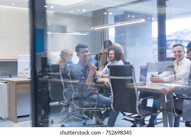 Group of a young business people discussing business plan at modern startup office building - Shutterstock ID 752698345