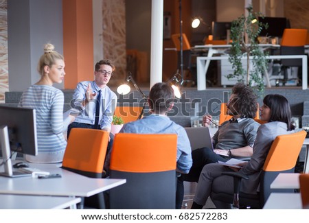 Group of a young business people discussing business plan  in the office
