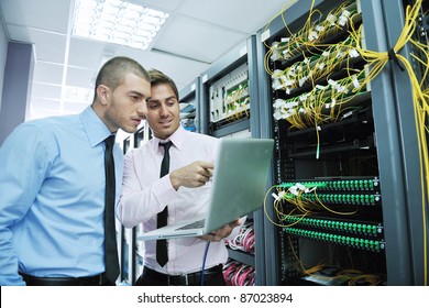 Group Of Young Business People It Engineer In Network Server Room Solving Problems And Give Help And Support