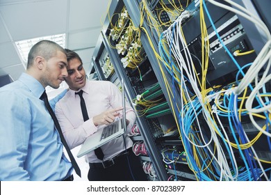 Group Of Young Business People It Engineer In Network Server Room Solving Problems And Give Help And Support