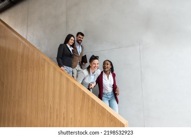 Group Of Young Business People Going To Cafeteria On Lunch Break To Eat And Drink Coffee After Successful Day At Work. Office Workers Going Home After Working On New Project.