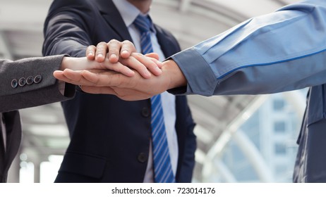 Group of young business people hands with stacking hands together expressing positive thinking, try positive action, teamwork concepts. - Shutterstock ID 723014176