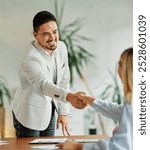 Group of young business people having a meeting shaking hands handshake introducing each other during meeting in the office. Teamwork and success concept