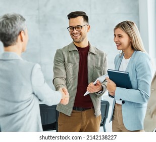 Group of young business people having a meeting shaking hands handshake introducing each other in the office. Teamwork and success concept - Powered by Shutterstock