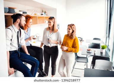 A Group Of Young Business People On Coffee Break In Office Kitchen.