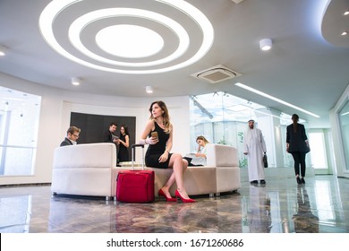 Group Of Young Business People Are Sitting On Sofa Waiting For An Interview Or Departure In The Office Lobby Or Airport Waiting Room.