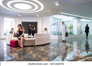 Group Of Young Business People Are Sitting On Sofa Waiting For An Interview Or Departure In The Office Lobby Or Airport Waiting Room.