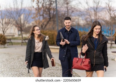 Group of young business people are walking and talking - Shutterstock ID 2205650659