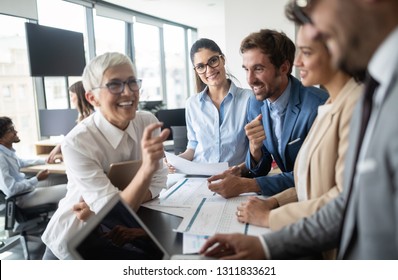 Group Of Young Business People Working And Communicating At The Office