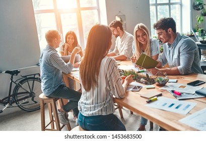 Group of young business people are working together in modern office. Creative people with laptop, tablet, smart phone, notebook. Successful hipster team in coworking. Freelancers. - Shutterstock ID 1453683500